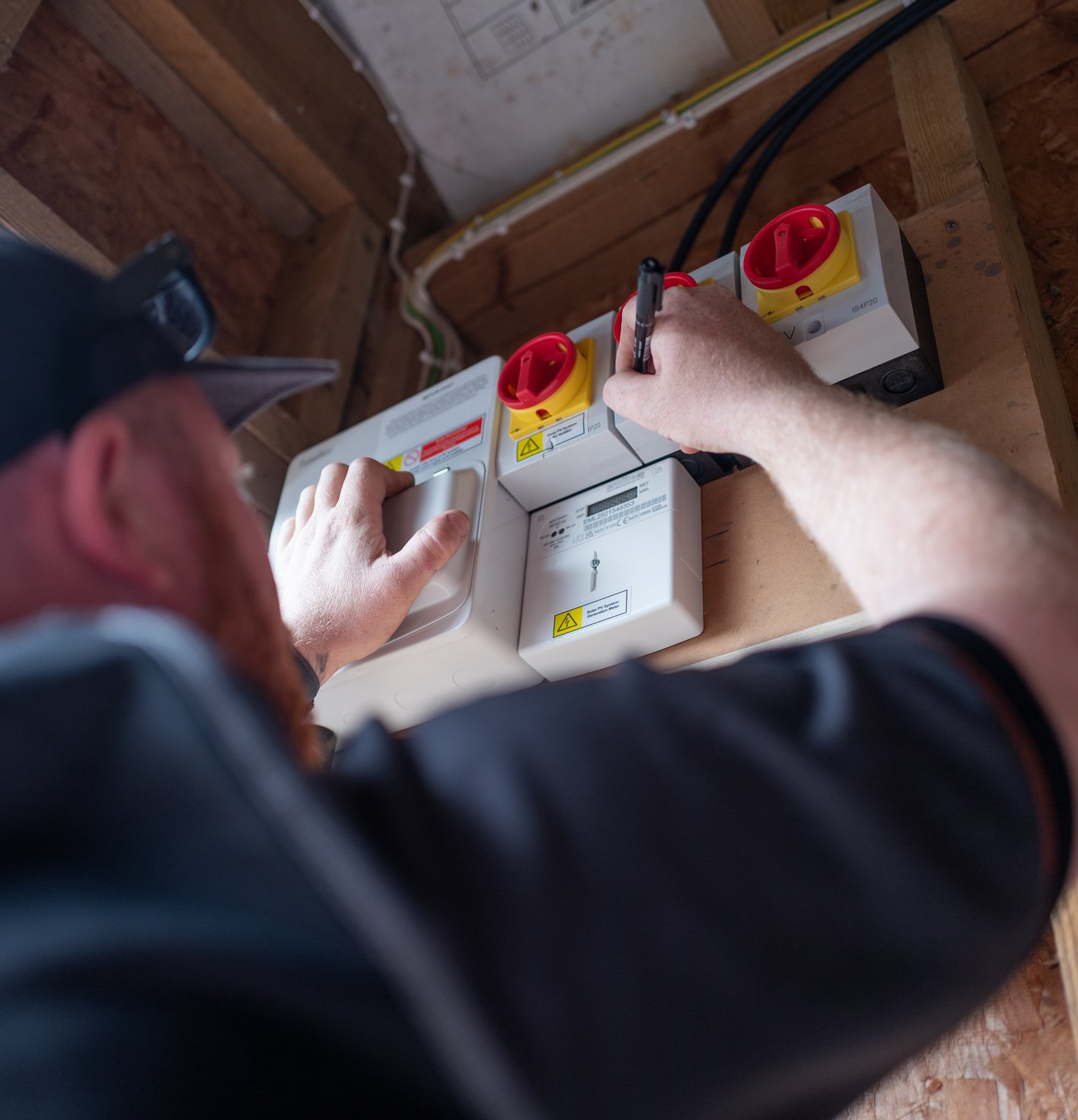 JellyWatt installer wiring the isolators for a home battery storage system