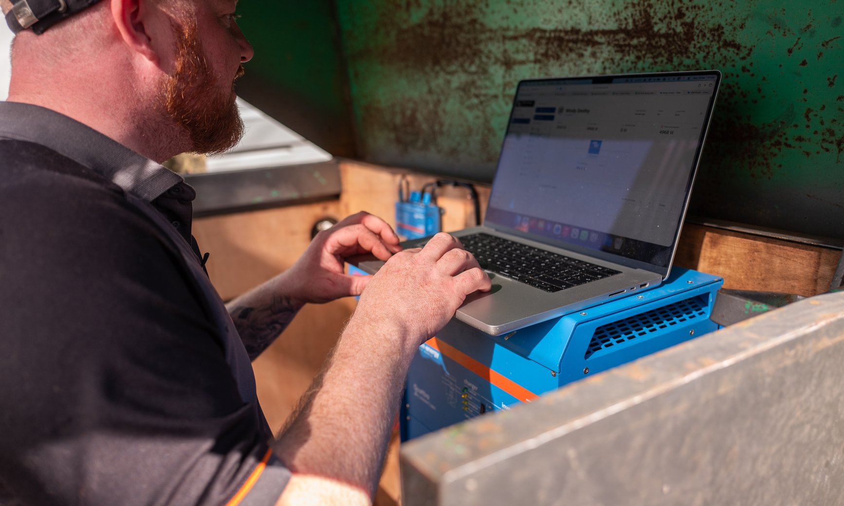 JellyWatt engineer commissioning a Victron home battery system on a laptop