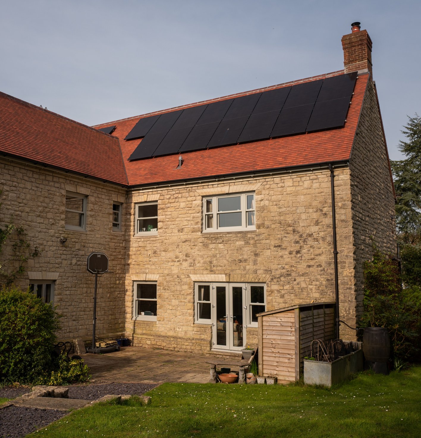 Solar panel array on a stone house, installed by JellyWatt Renewables