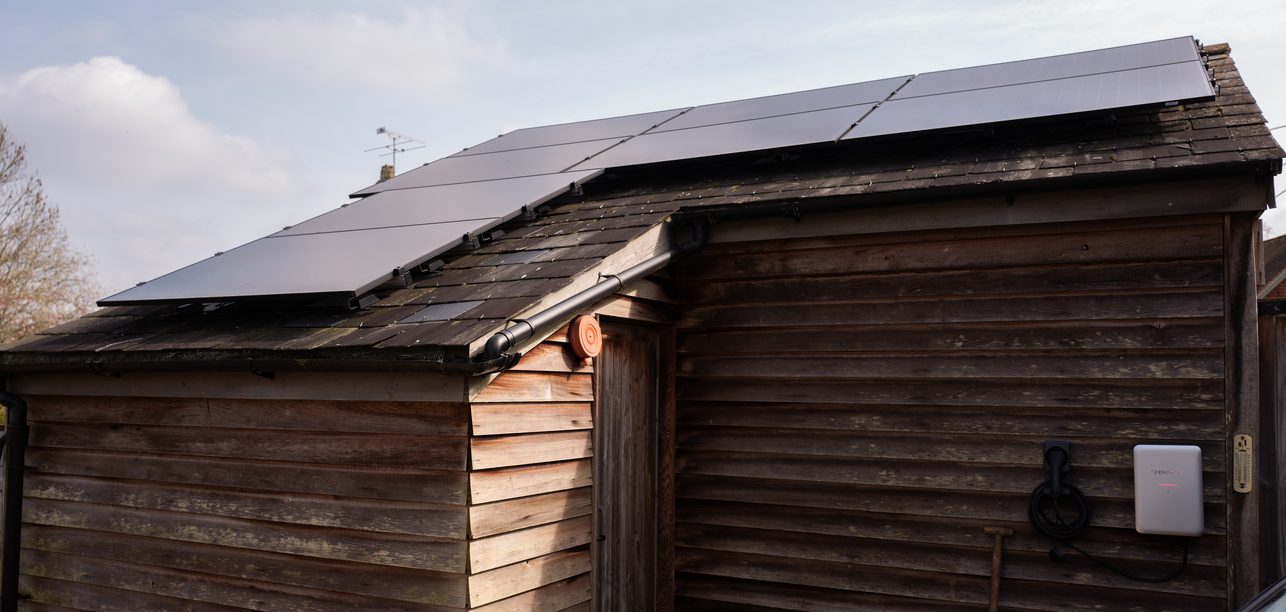 Solar panels on a timber garage with an Enphase EV charger, installed by JellyWatt