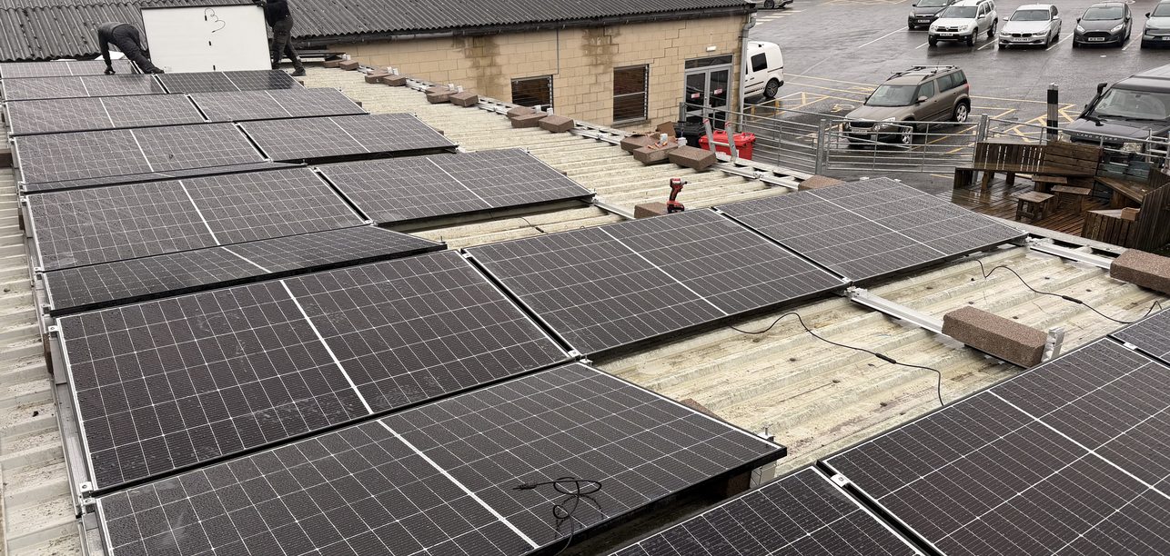 Large solar array on a commercial building roof, installed by JellyWatt