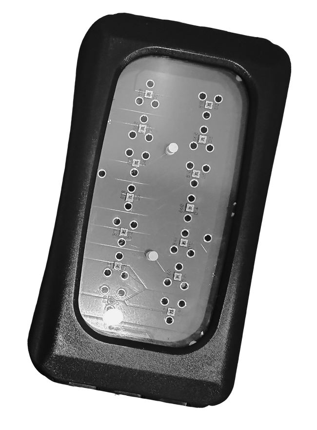 A close-up of a black device with a transparent top revealing a circuit board with multiple holes and circuits.