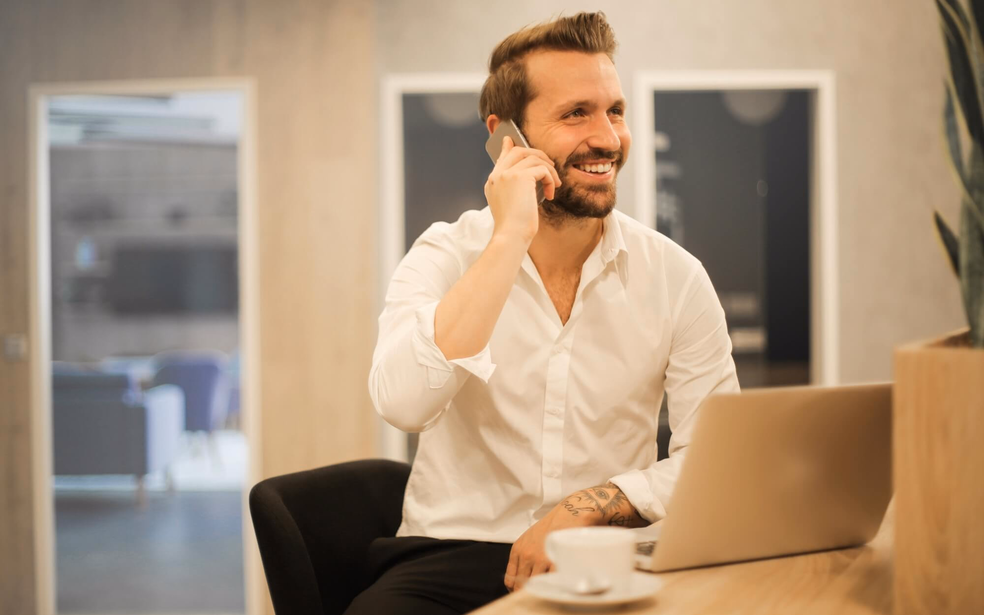 Man talking on his cell phone in his office