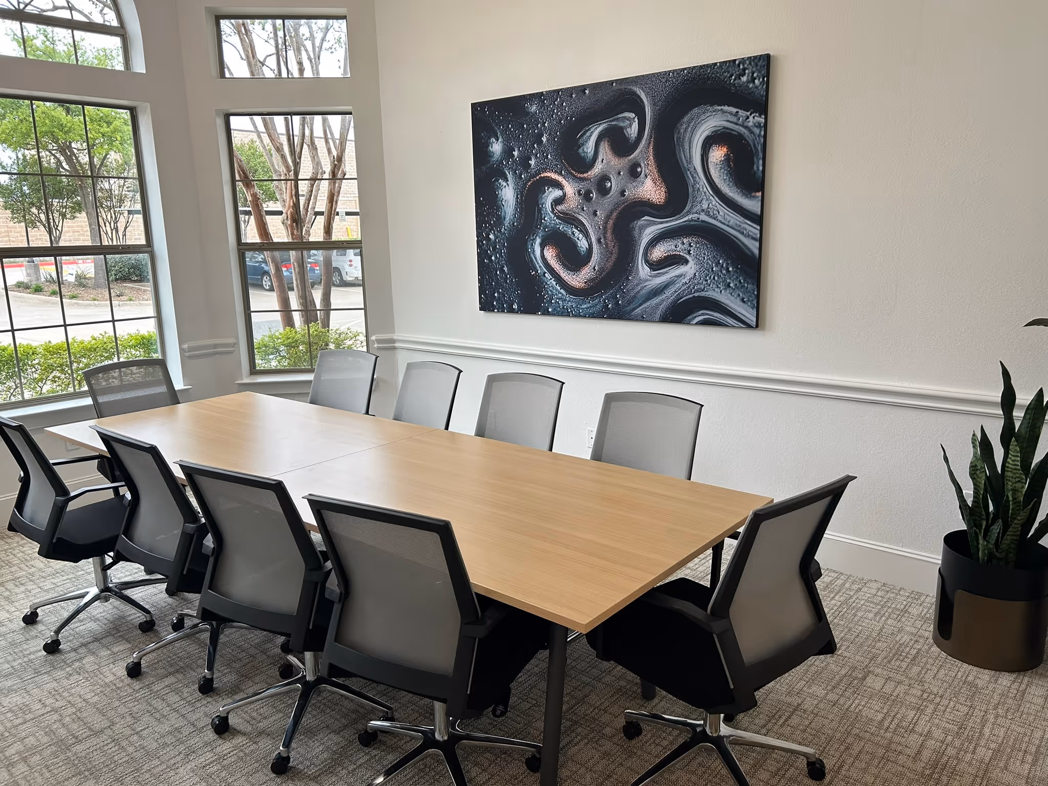 Completed leasing office art installation and conference table assembly by A‑Breasy in Lewisville, featuring clean alignment and modern design