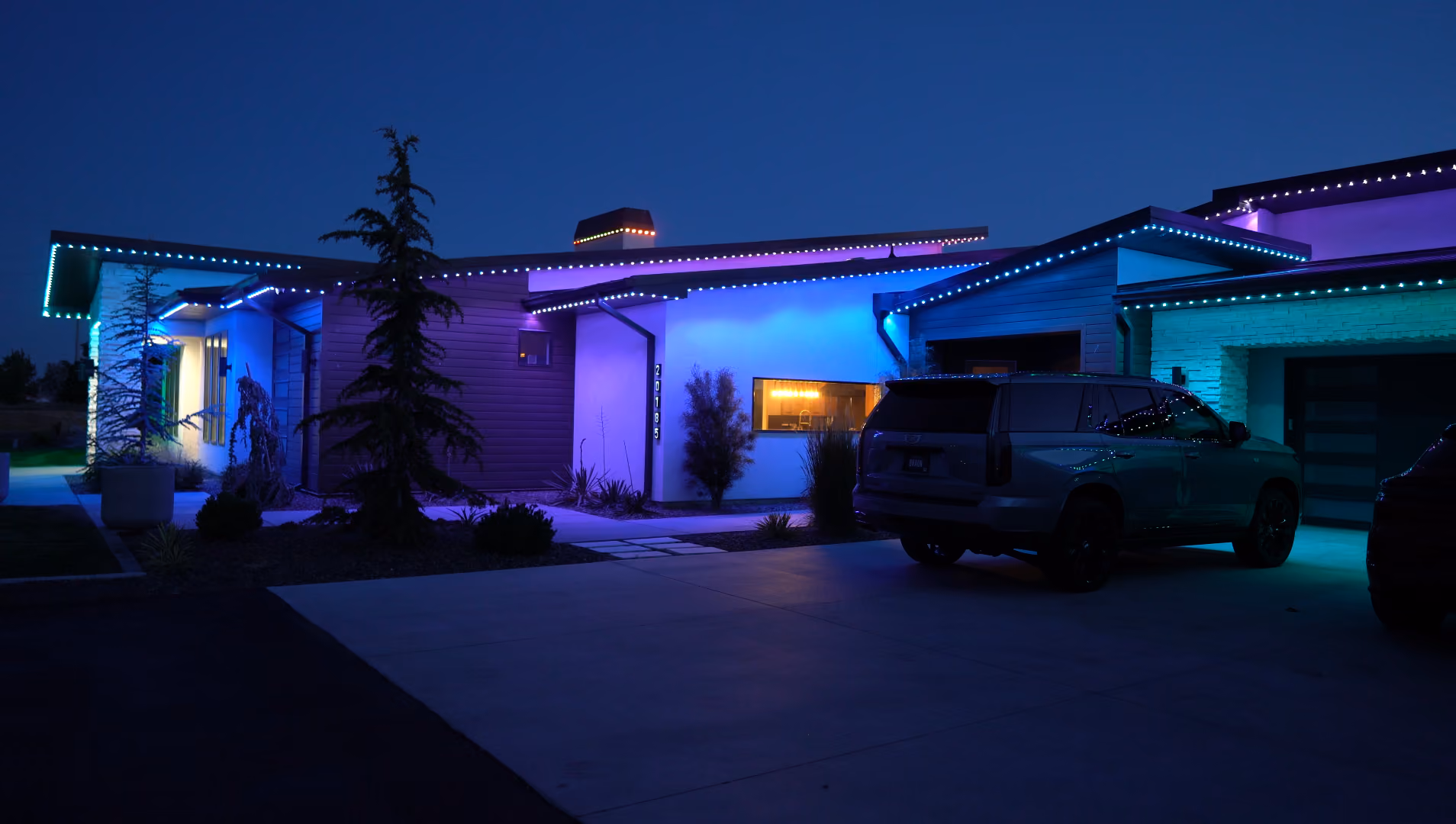 Permanent outdoor lighting system illuminating a house