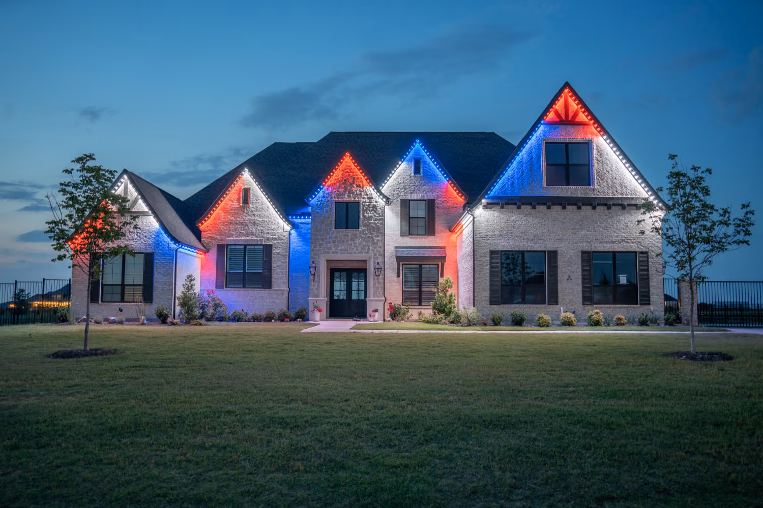 Bosso permanent outdoor lighting installed on a house at night