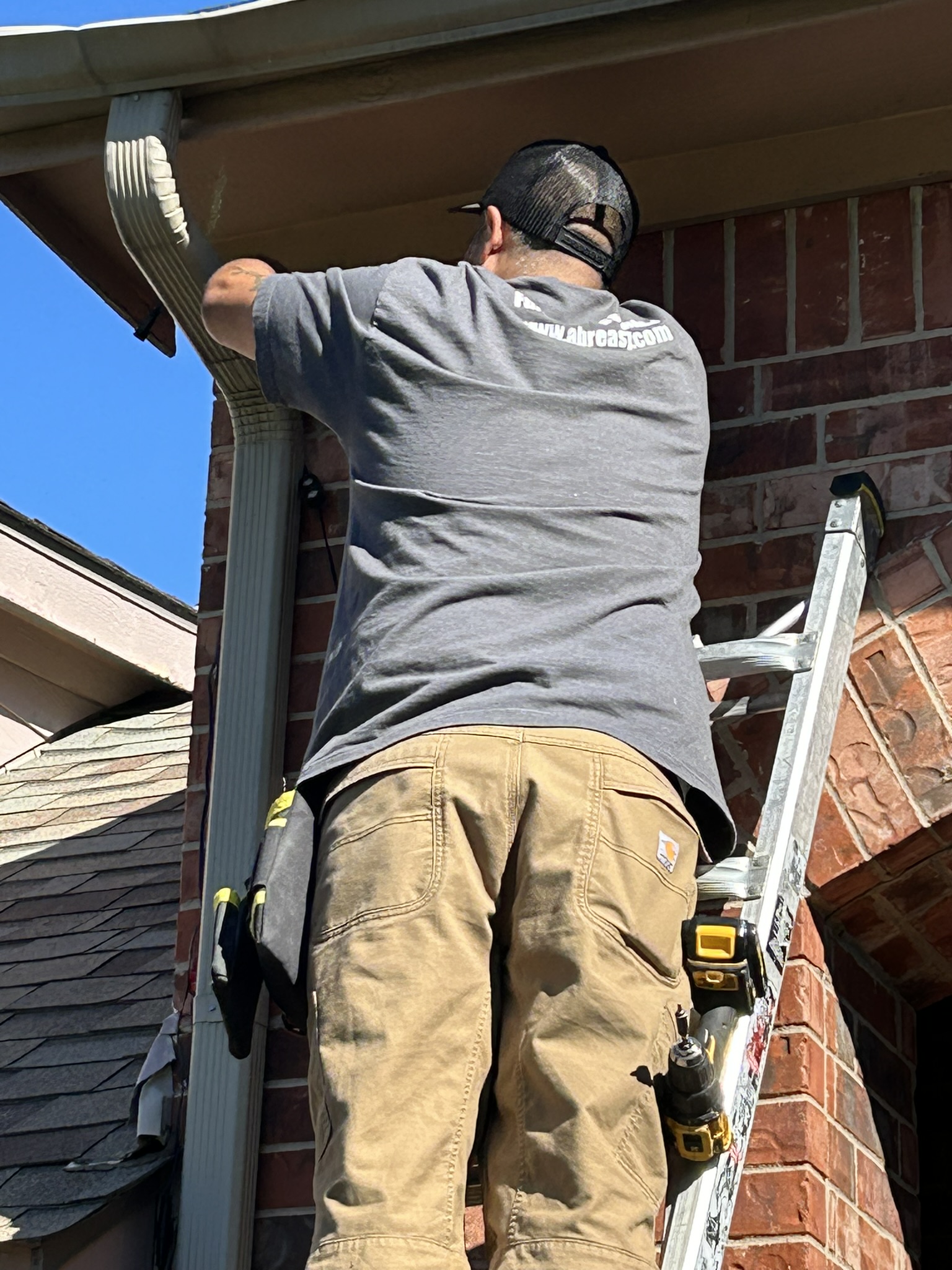 A-Breasy technician installing holiday lights