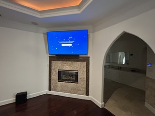 Television professionally mounted above a fireplace by A-Breasy