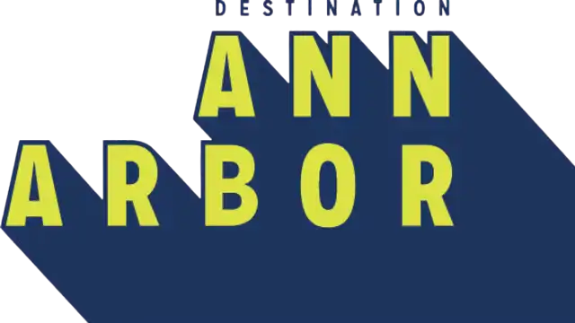 Text logo with large yellow letters spelling 'ANN ARBOR' on a dark blue and black background, with smaller text 'DESTINATION' above.