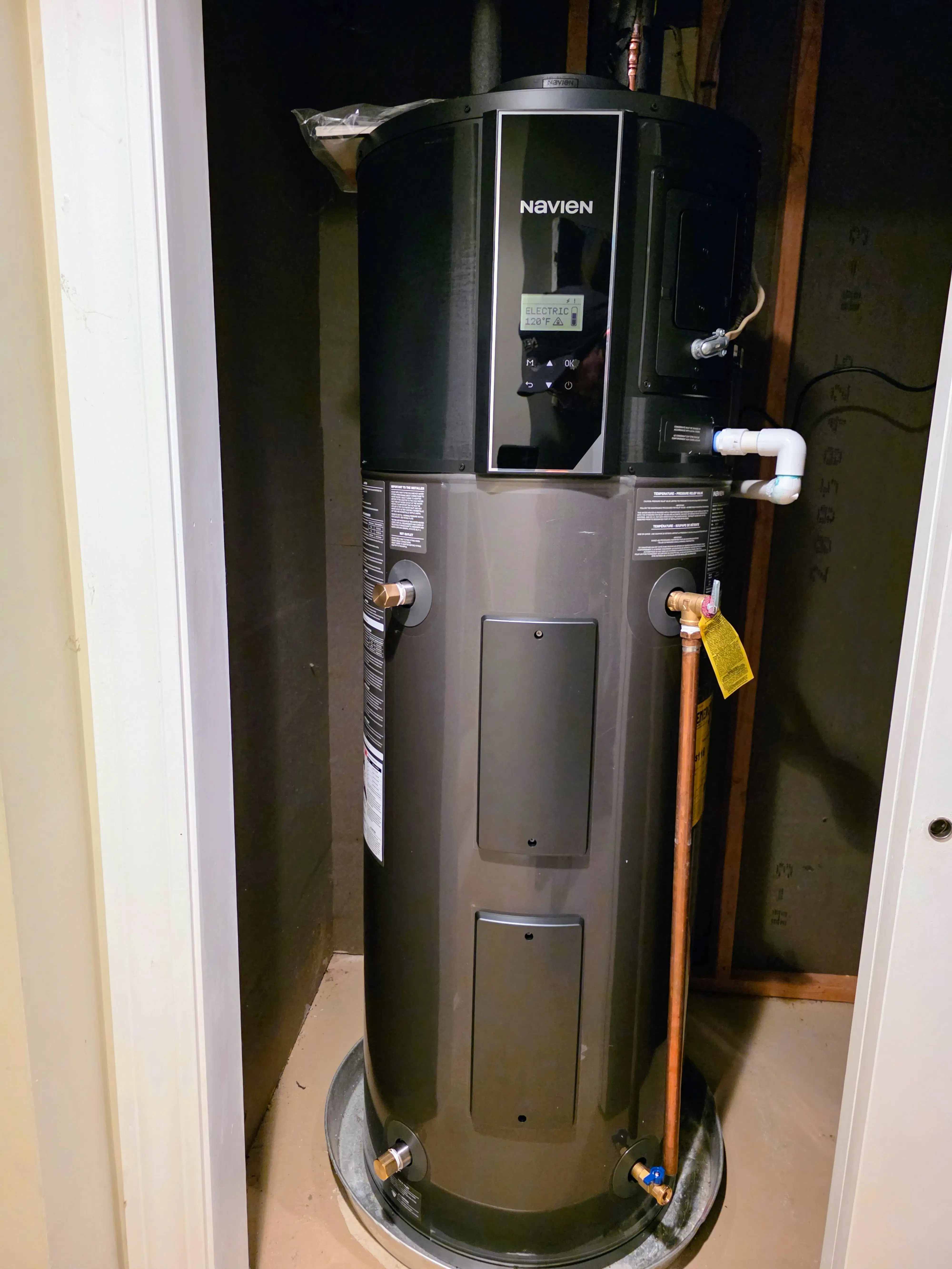 Newly installed hybrid water heater unit professionally connected with copper piping