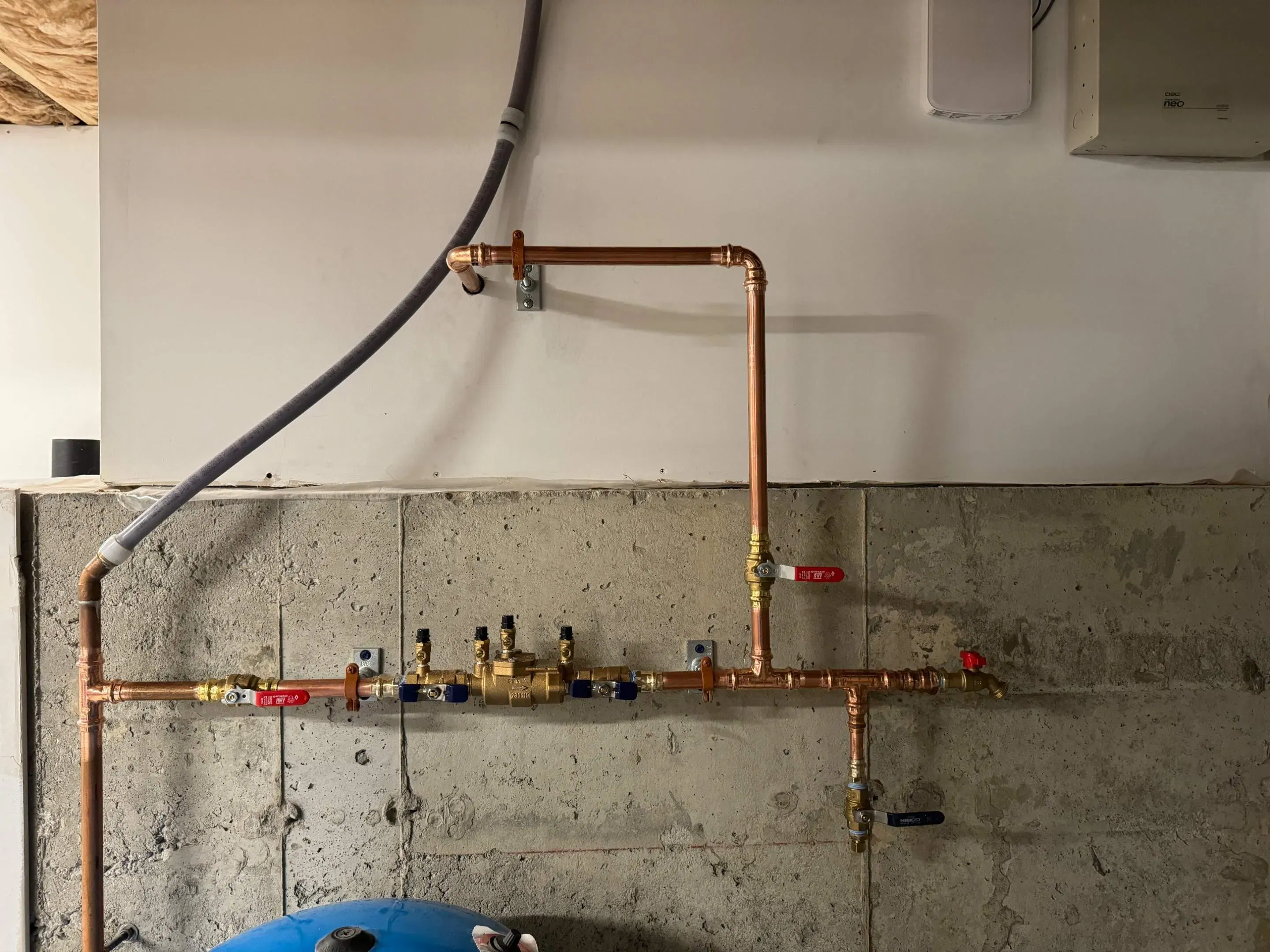 Professionally installed copper plumbing manifold system showing high-quality workmanship