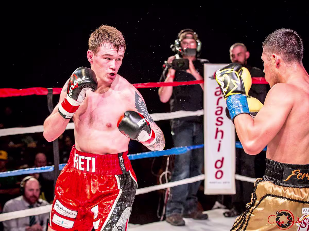 Action shot of two fighters in the ring during a live-streamed boxing event for Dekeda.