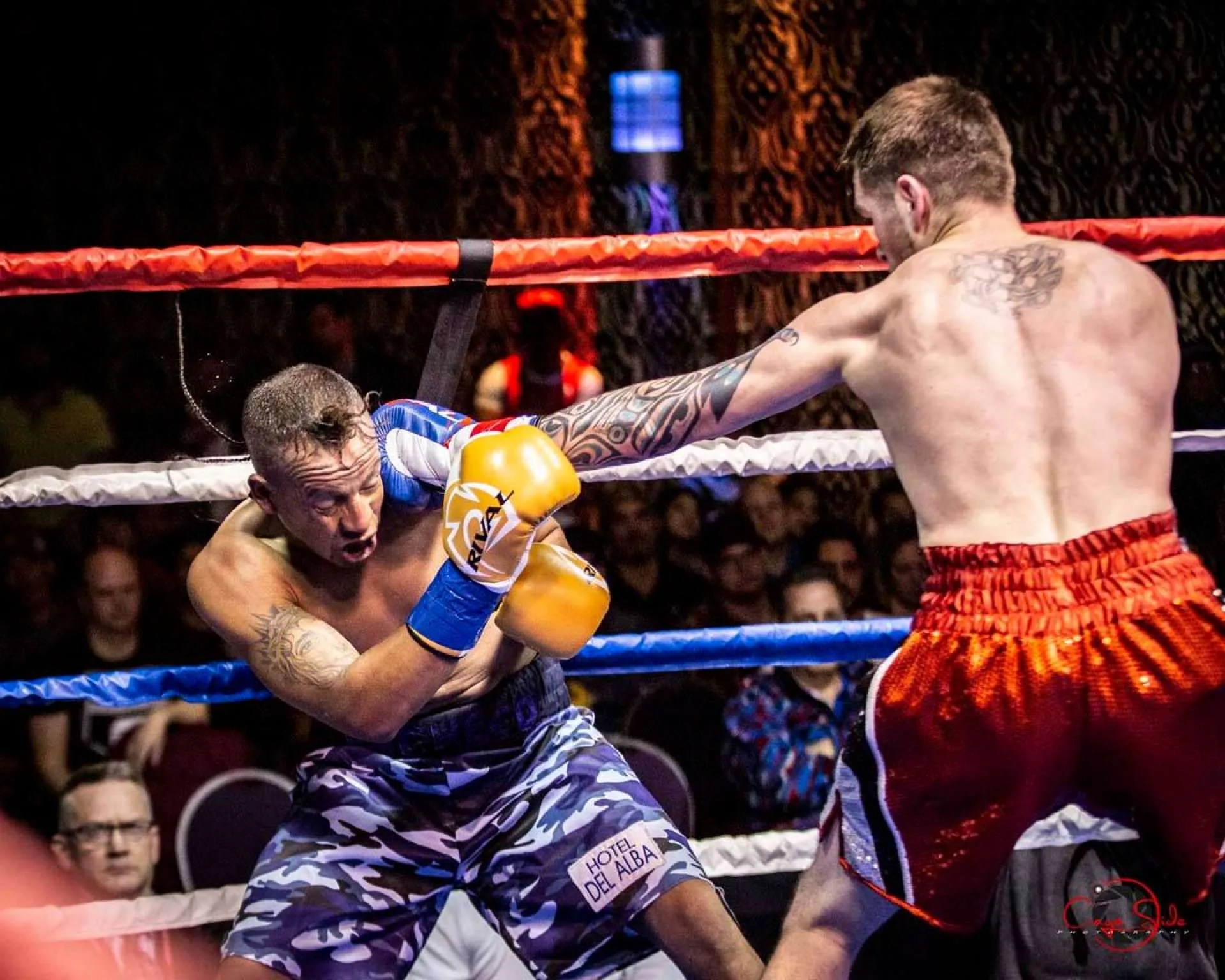 action shot of a man being punched in the boxing ring