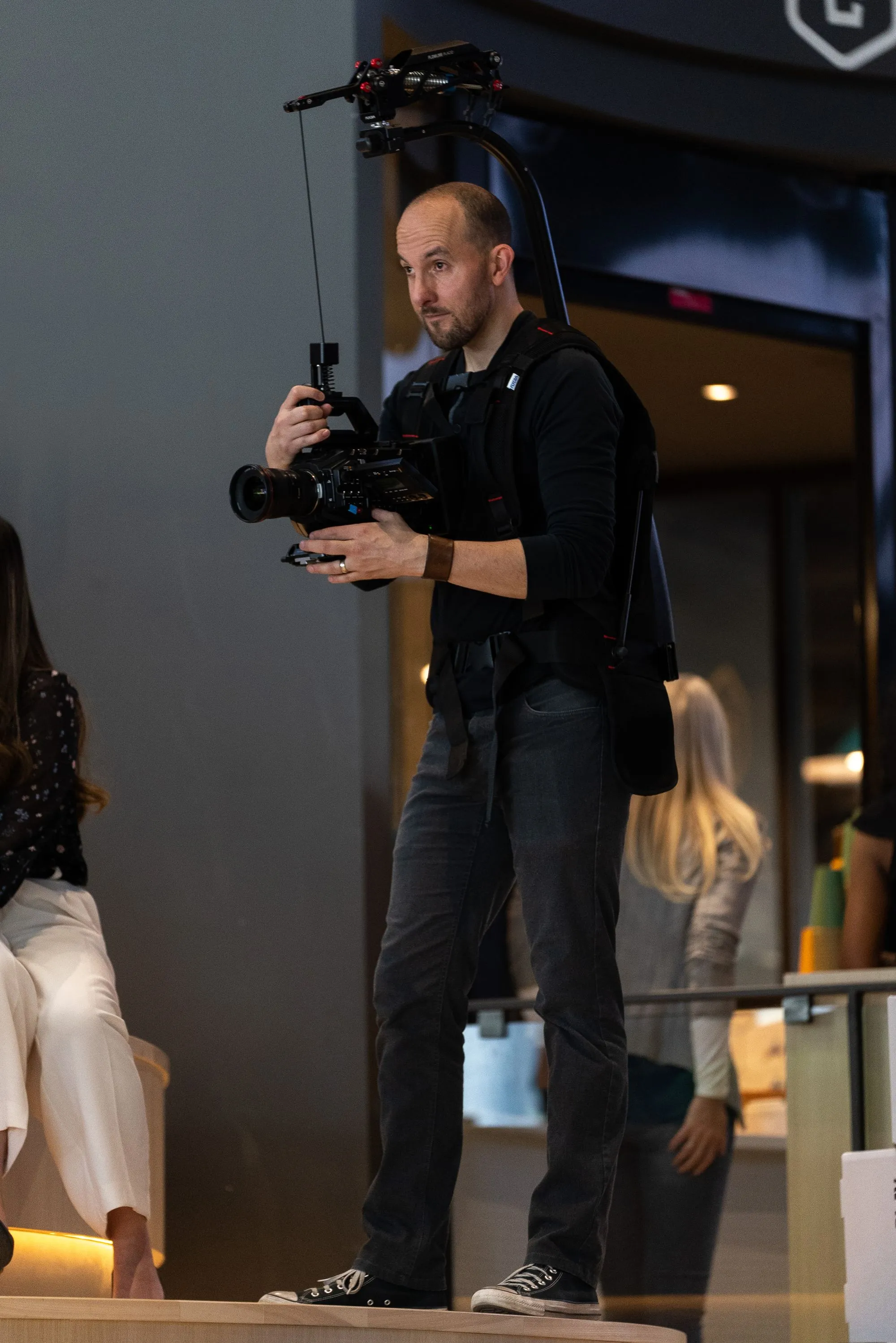 camera man walking around with rig strapped on for camera stability