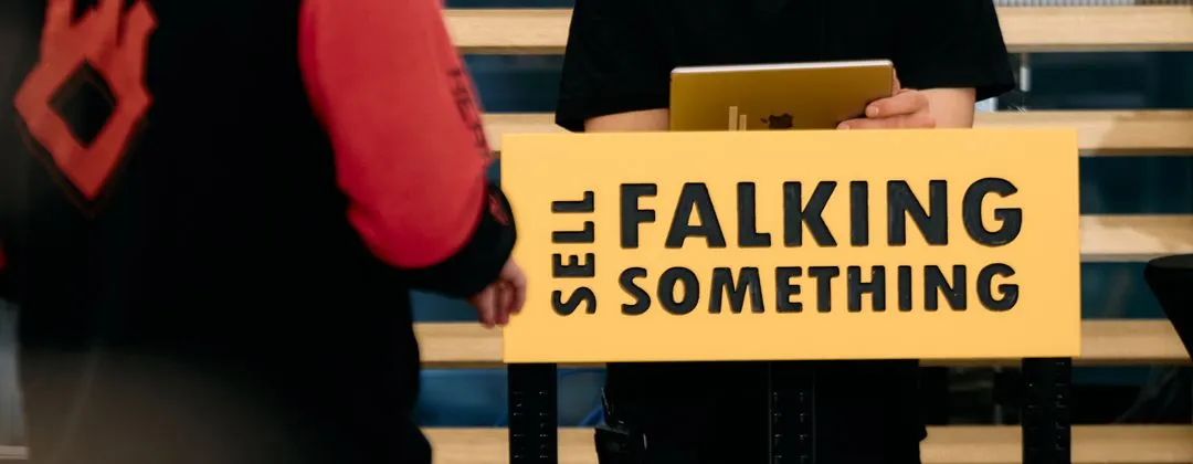 a close up of the podium that reads "Sell Falking Something"