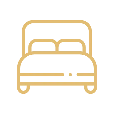 Minimalist gold line icon of a bed with headboard and pillows on a black background.