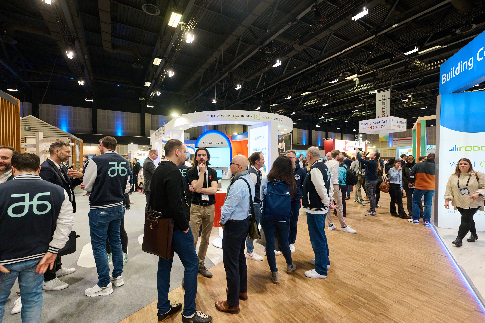 Crowded exhibition hall aisle at CCW 2026 in Berlin, with exhibitor stands and networking signage between the booths.