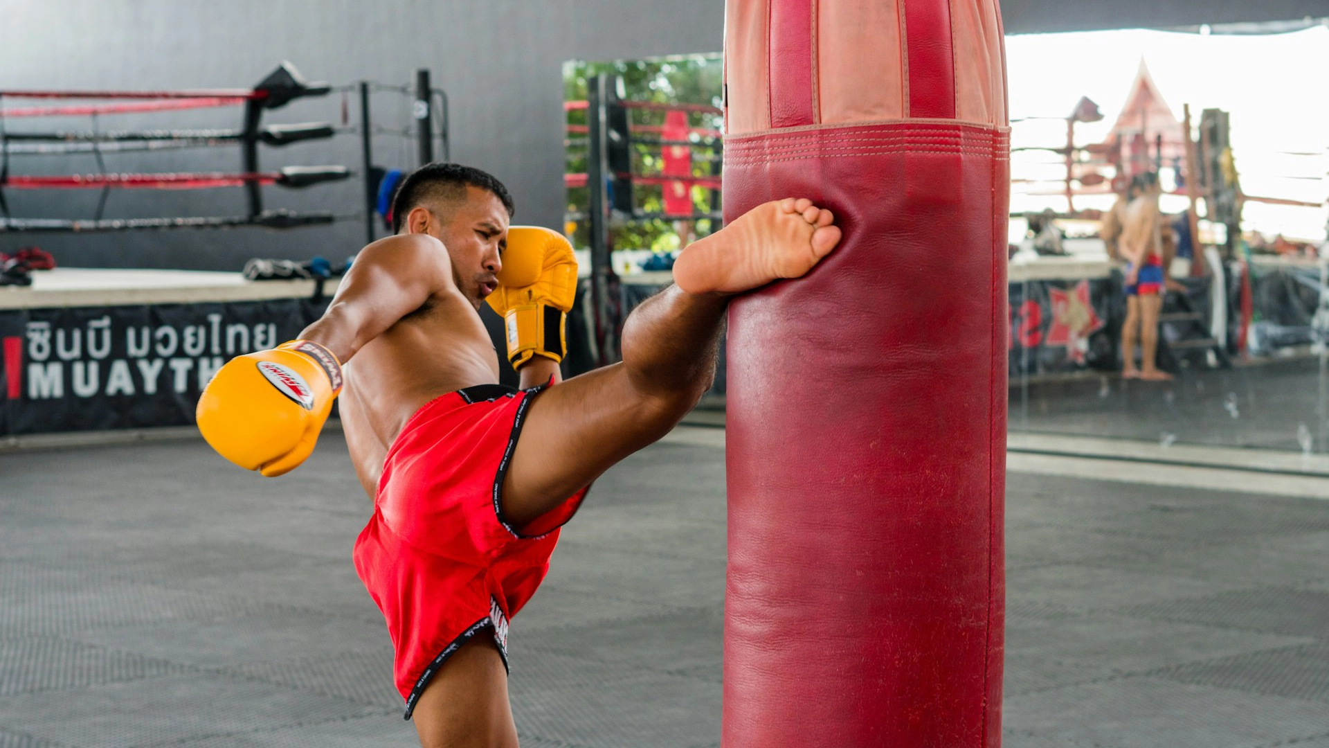 Muay Thai Athlete Roundhouse Kick Heavy Bag Training