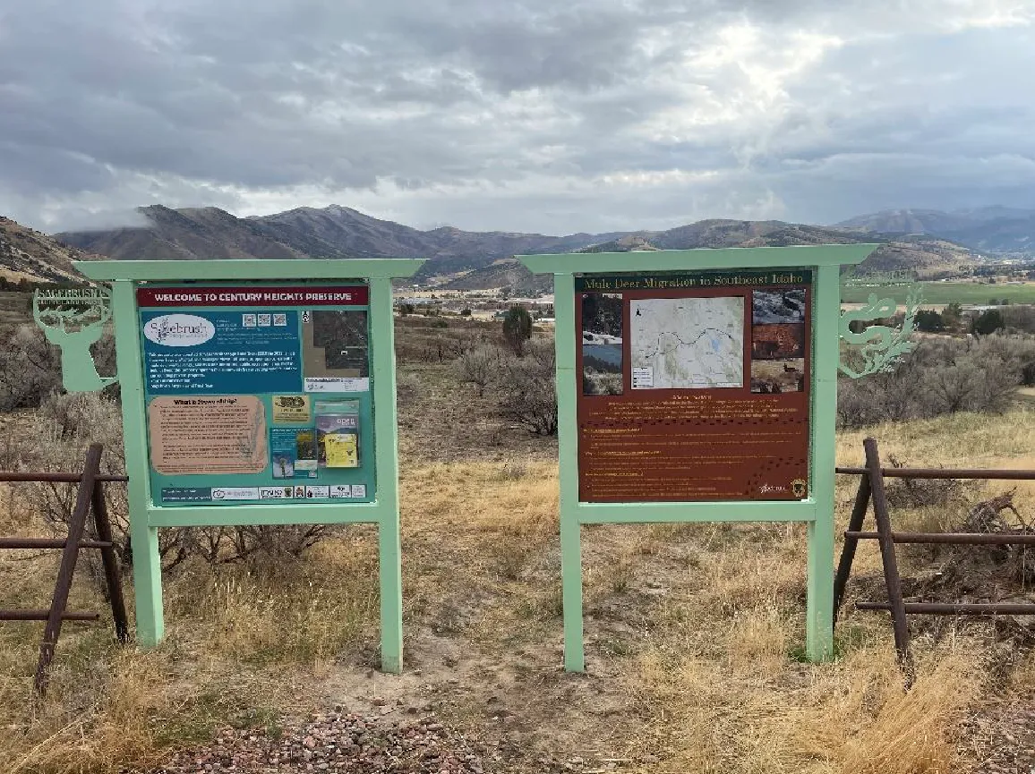 Two wooden educational kiosks at a trailhead providing information on wildlife habitat and public access at the Boise River WMA.