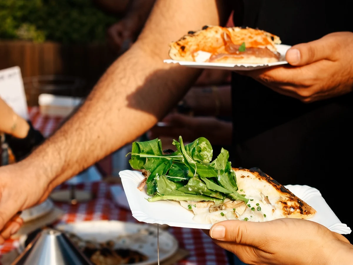 Caterer handing over a plate of food