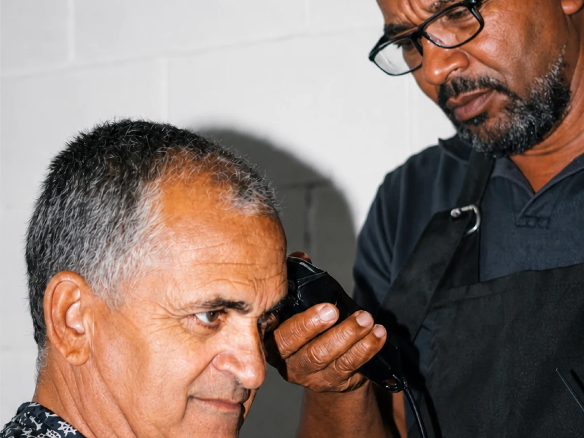 Barber trimming a client's hair