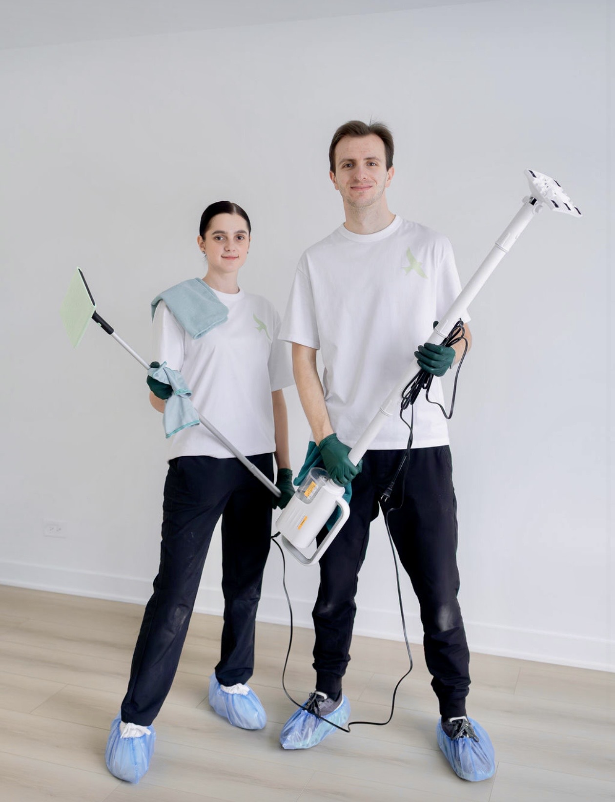 Anyuta and MK of Lastivka Cleaning Company in Chicago holding their cleaning tools