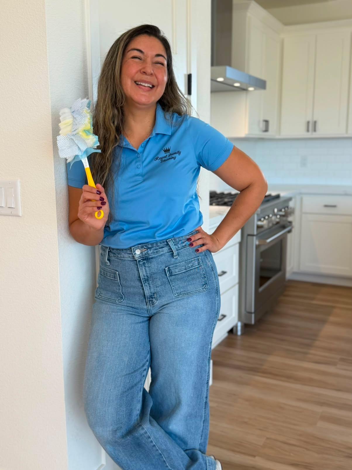 Marina of Royal Family Cleaning in Chico, CA smiling in a kitchen and holding a duster
