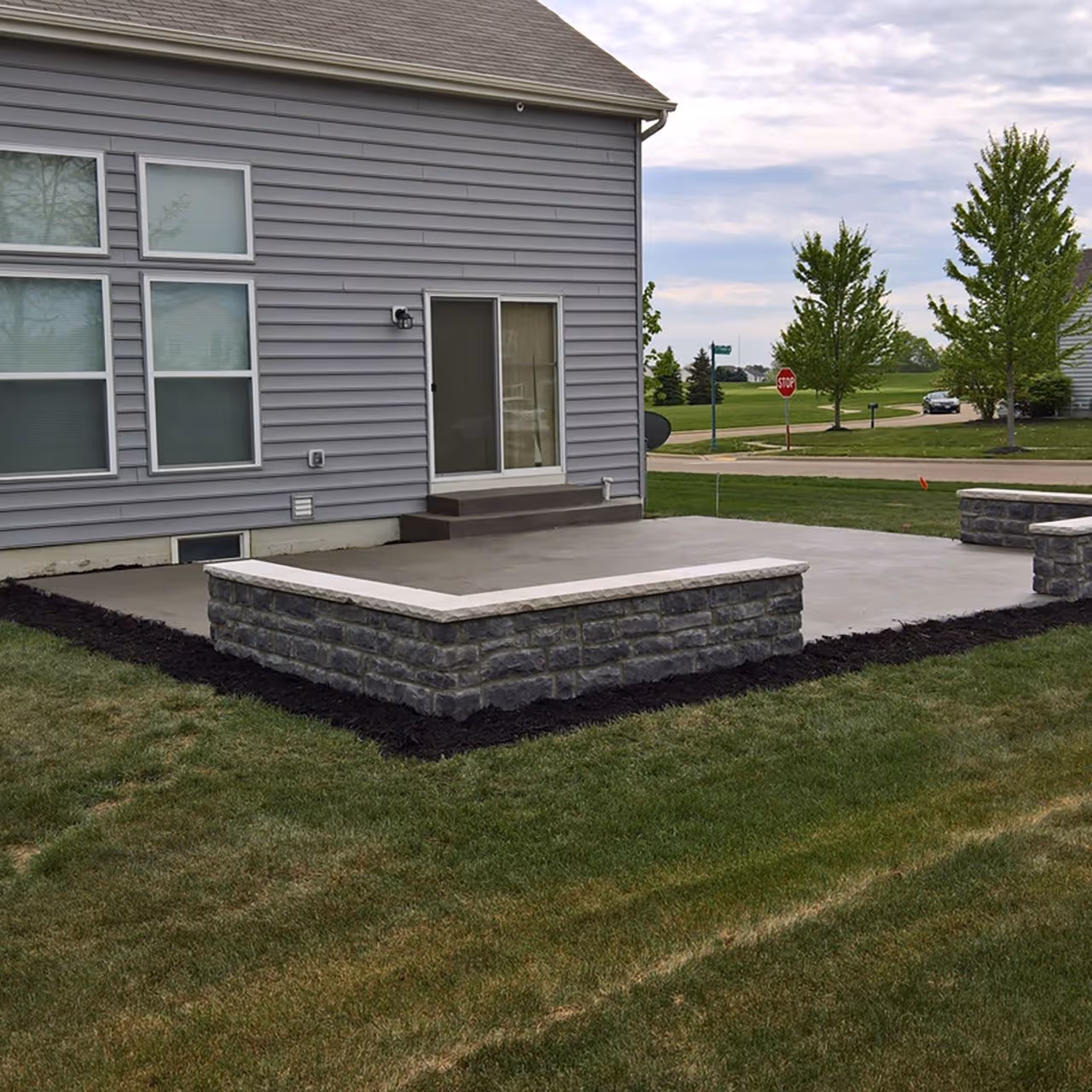 Paver patio outdoor living space by Landa Construction Services