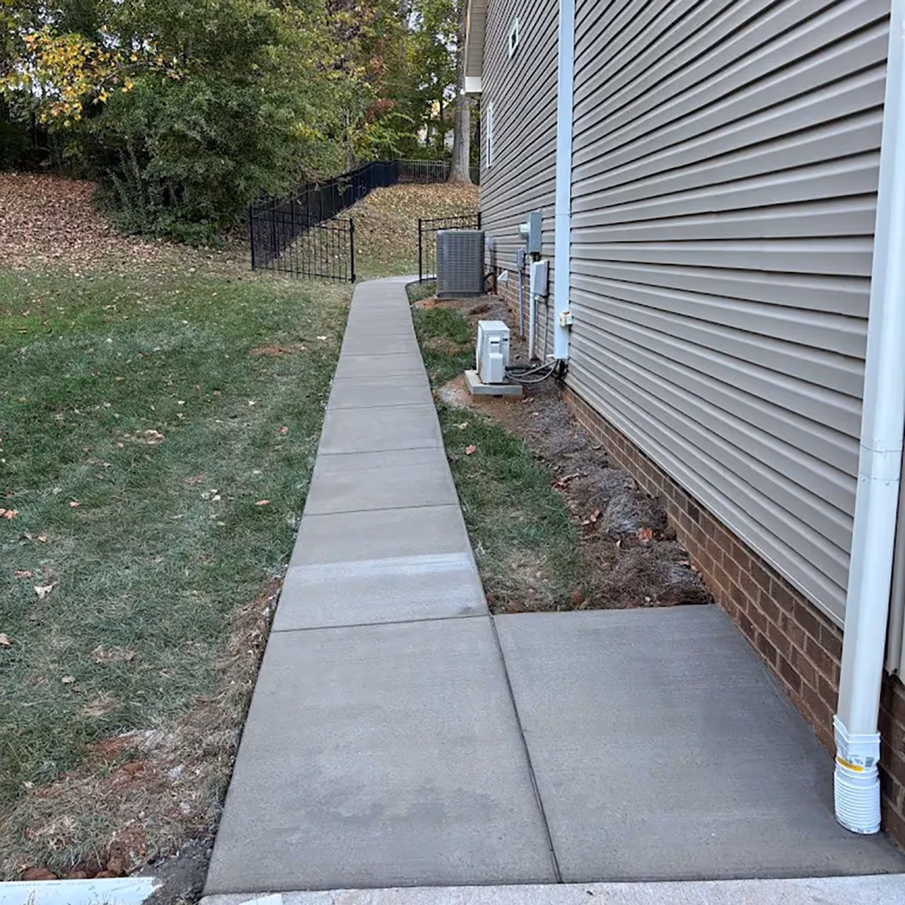 Concrete walkway installation with smooth finish for durable and clean residential pathways by Landa Construction Services