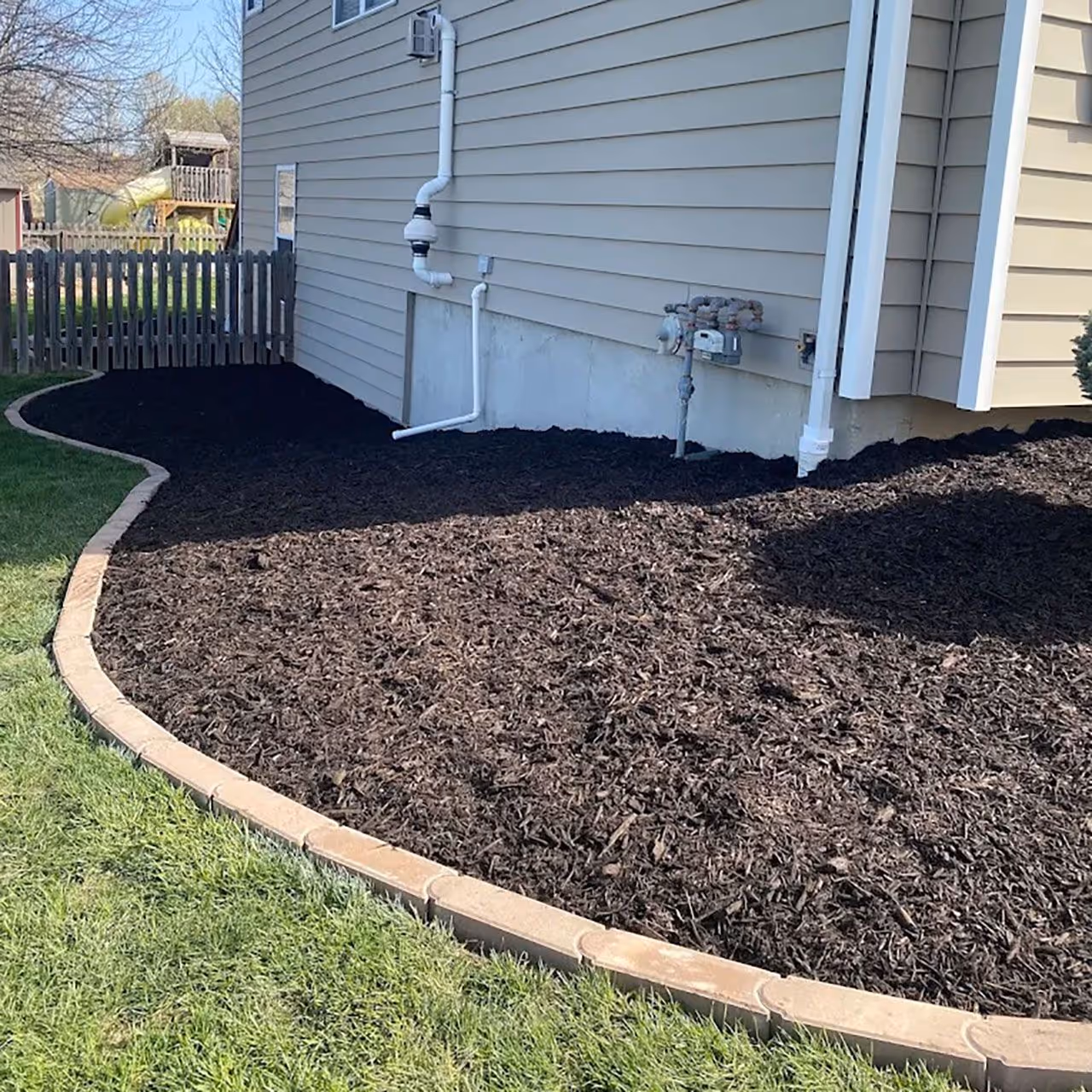 Mulch installation for clean landscape beds and improved curb appeal by Landa Construction Services
