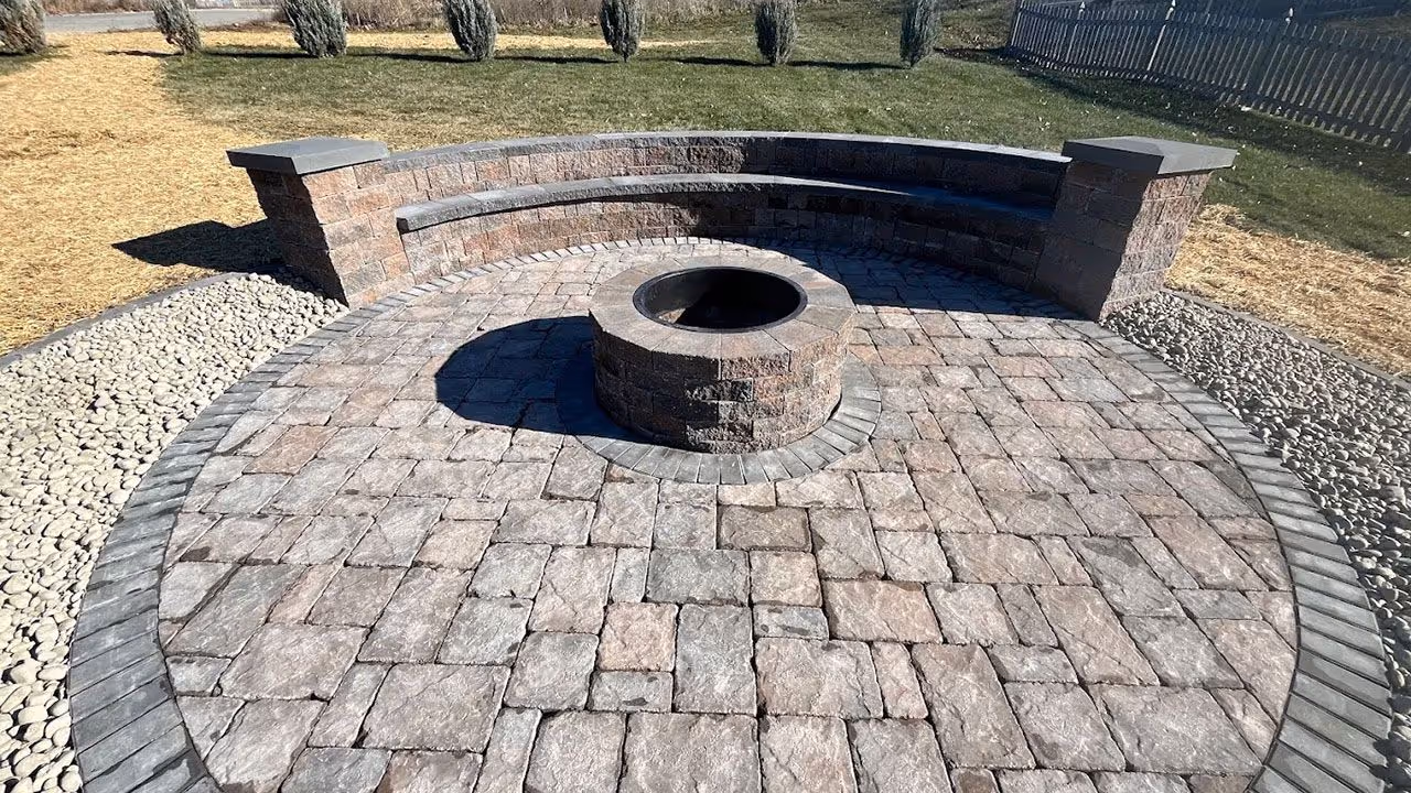 Outdoor living space with pavers and landscaping features