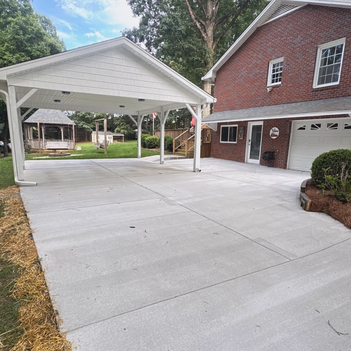 New concrete driveway installation enhancing residential curb appeal and property value by Landa Construction Services.