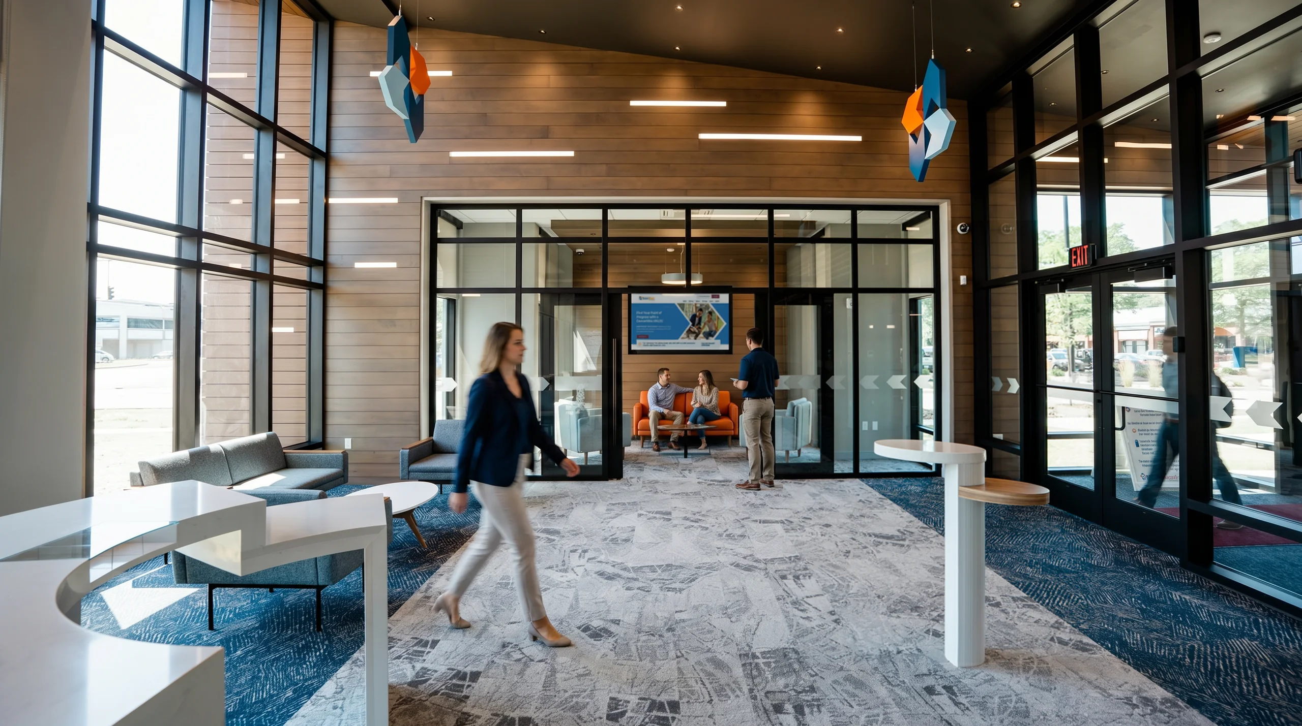 Bright branch lobby with wood-paneled walls, glass-walled consultation room, and lounge seating designed by Solidus
