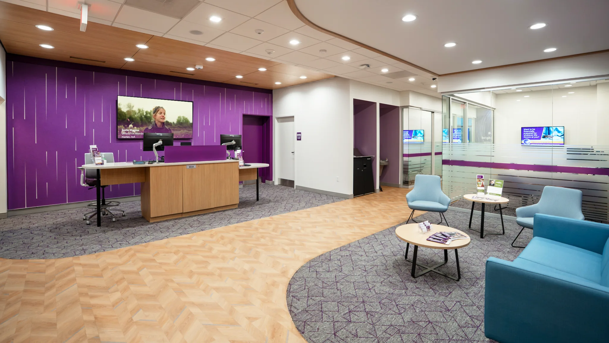 Renovated UMassFive East Longmeadow lobby with purple feature wall, teller pod, and lounge seating