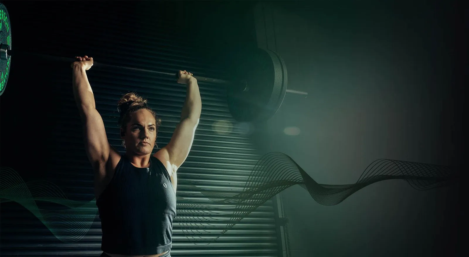 Female weightlifter completing a jerk