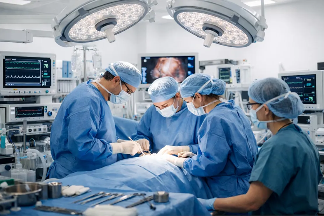 Surgical team performing a procedure under operating room lights, representing Barritus Capital's focus on clinical excellence and healthcare operations.