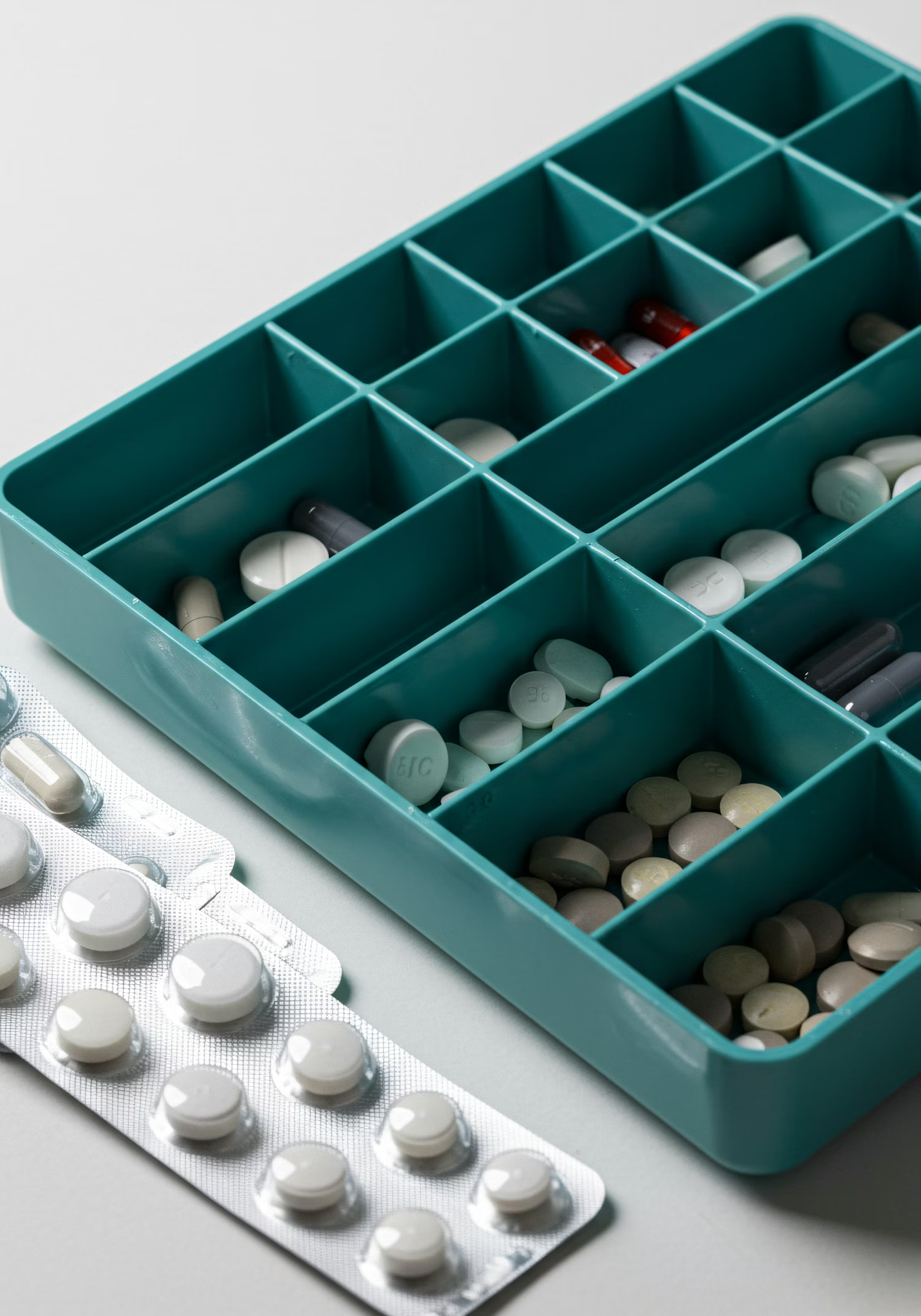 Pill organizer filled with medications, representing Barritus Capital’s focus on pharma services and operational healthcare platforms.