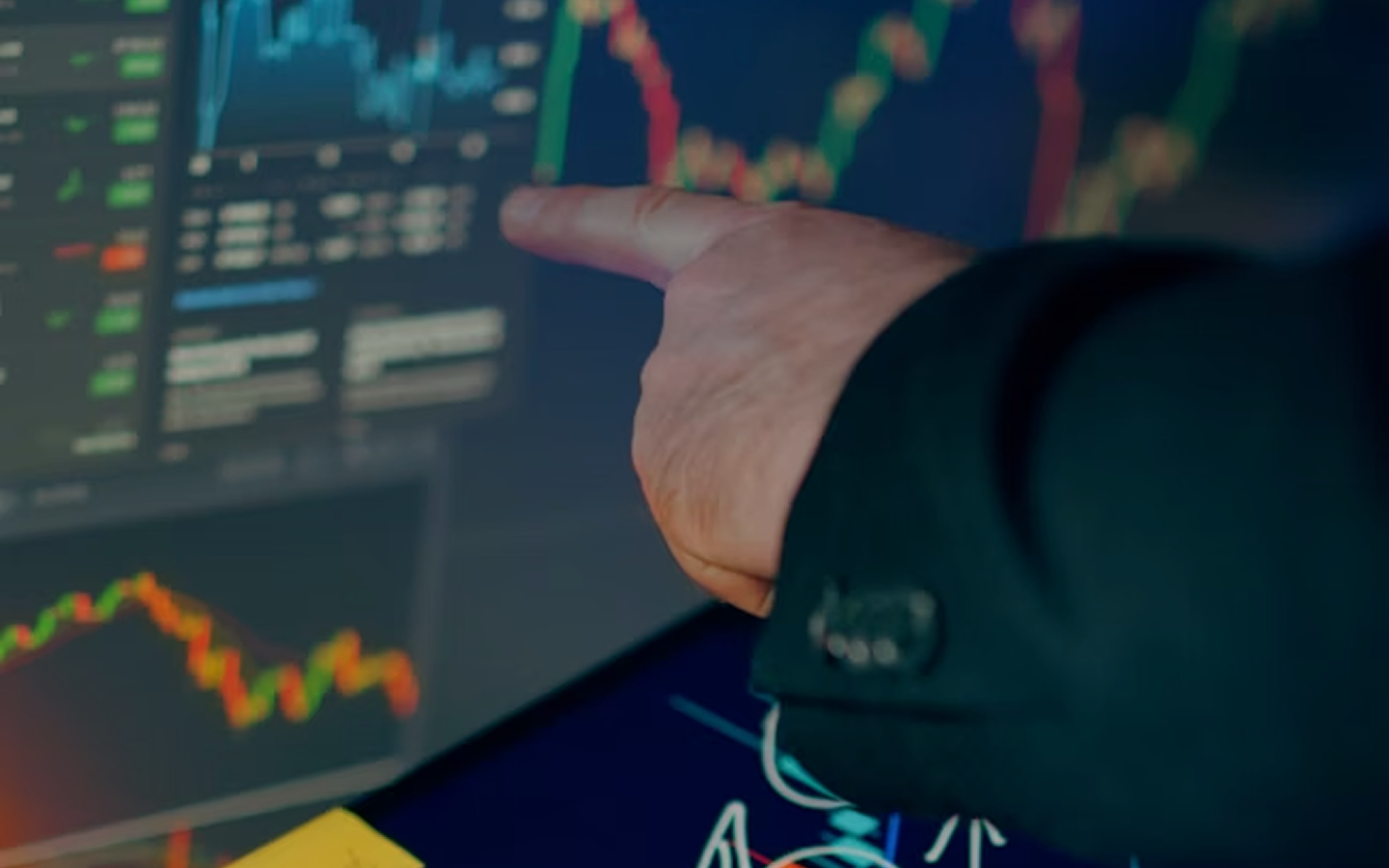 Hand pointing to data on a screen, symbolizing a strategic and disciplined investment platform for healthcare growth.