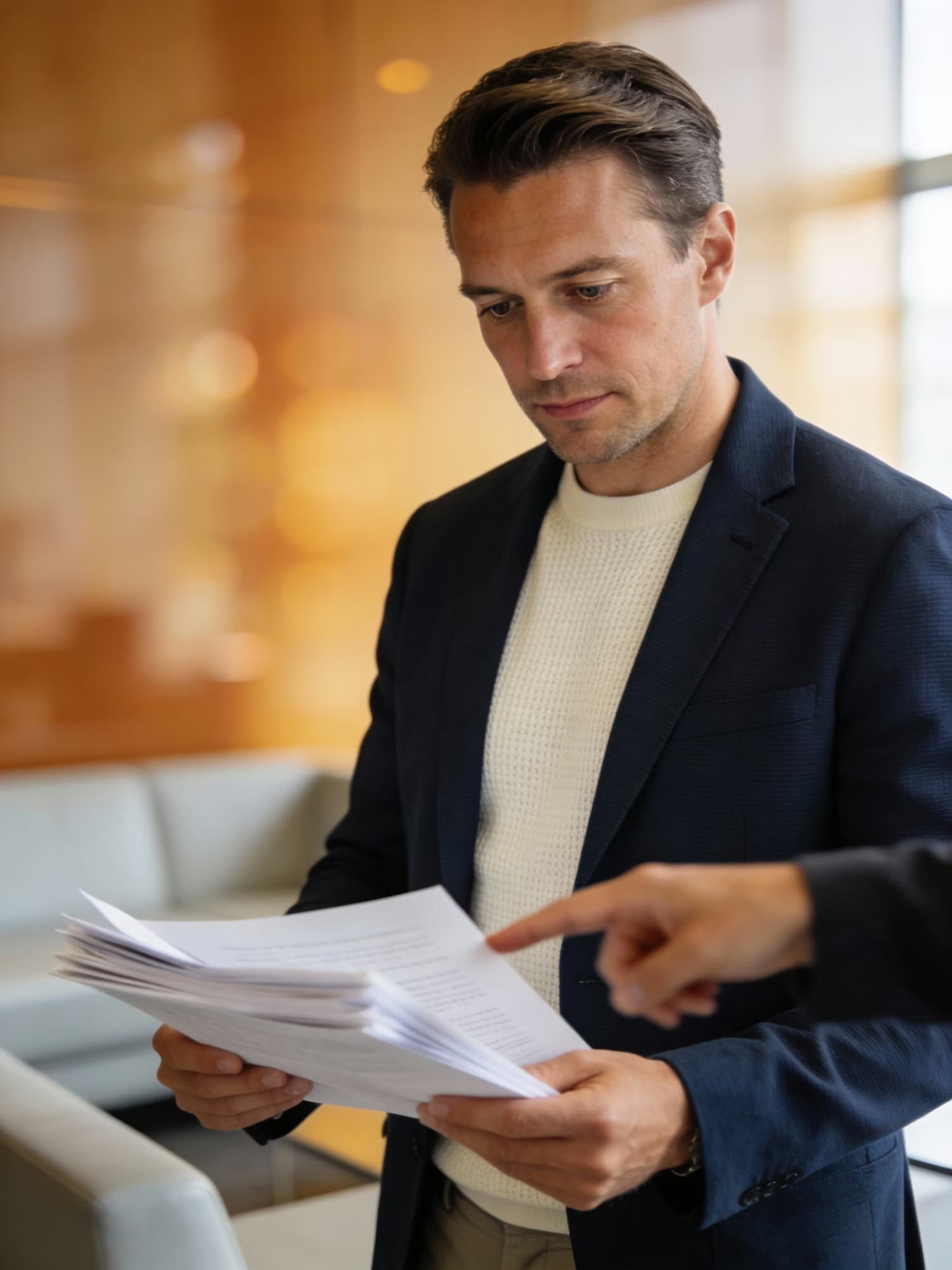 An executive reviewing financial reports, representing the disciplined diligence and evaluation of healthcare business opportunities.