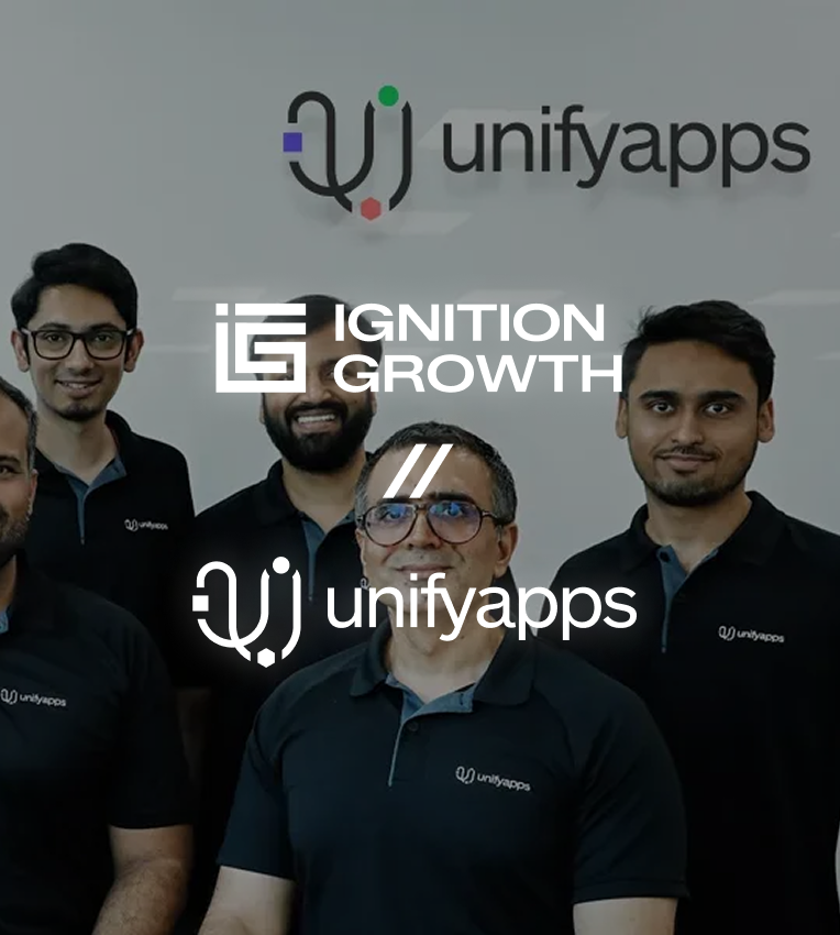 Group photo of five men wearing black unifyapps polo shirts standing in front of a wall with the unifyapps logo, overlaid with Ignition Growth and unifyapps logos.
