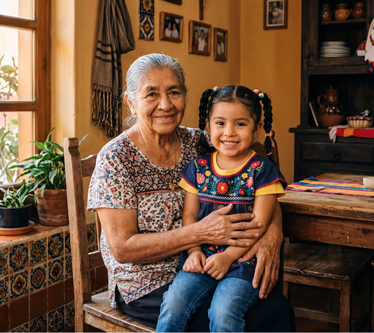 Smiling elderly woman holding a young girl with braided hair in a cozy home interior.