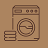 Icon of a front-loading washing machine with folded towels beside it.
