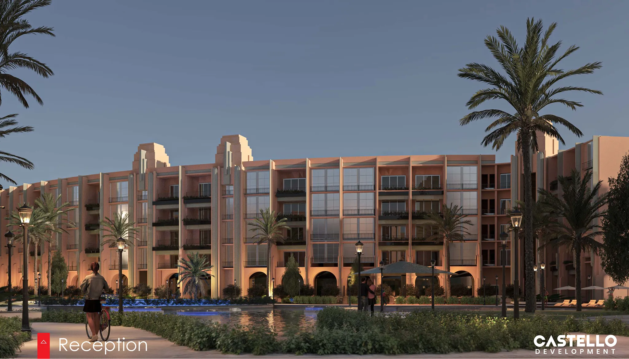 Evening view of a modern multi-story building with balconies, surrounded by palm trees and a reflecting pool, with people walking and a person with a bicycle nearby.