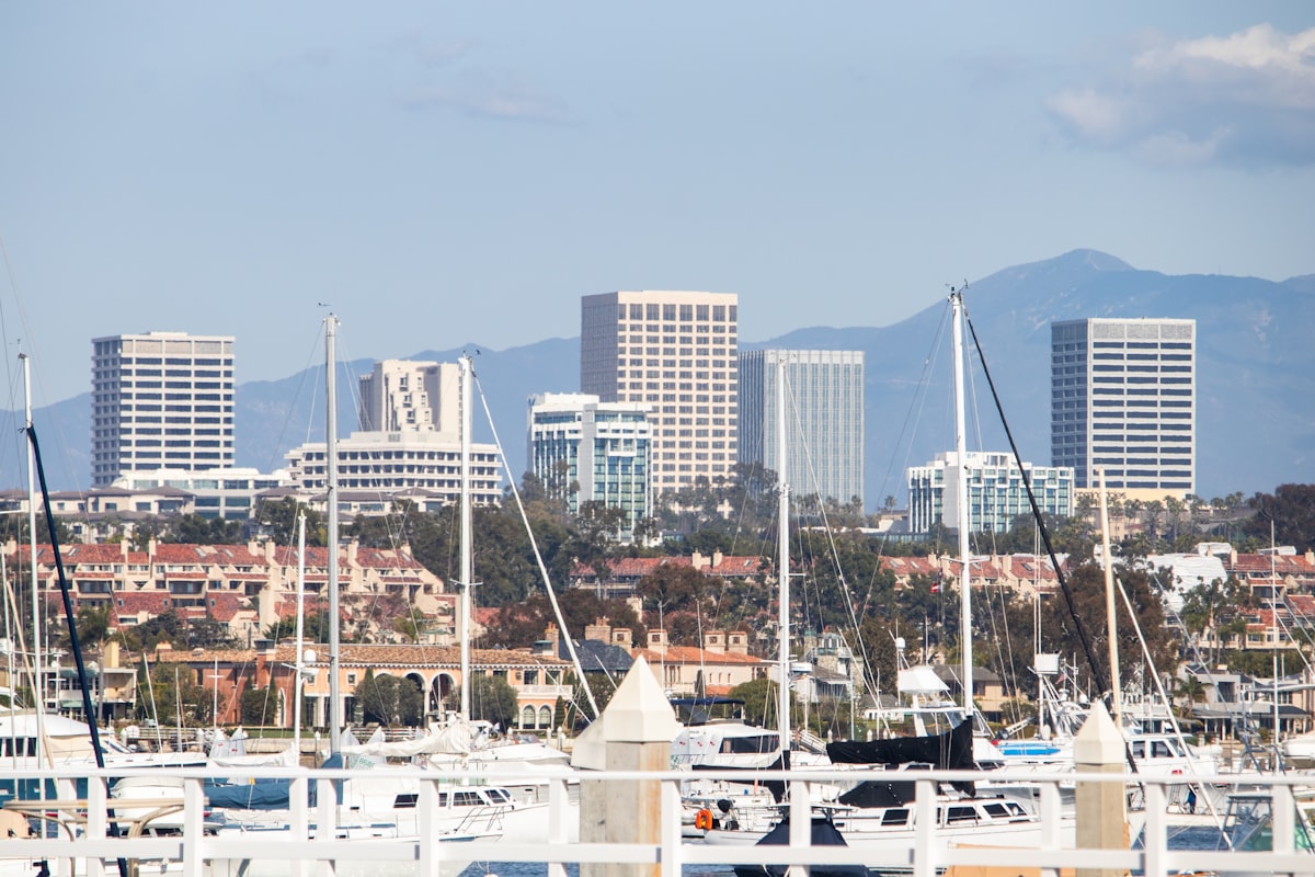 Newport Beach harbor with luxury boats and Balboa Peninsula coastline