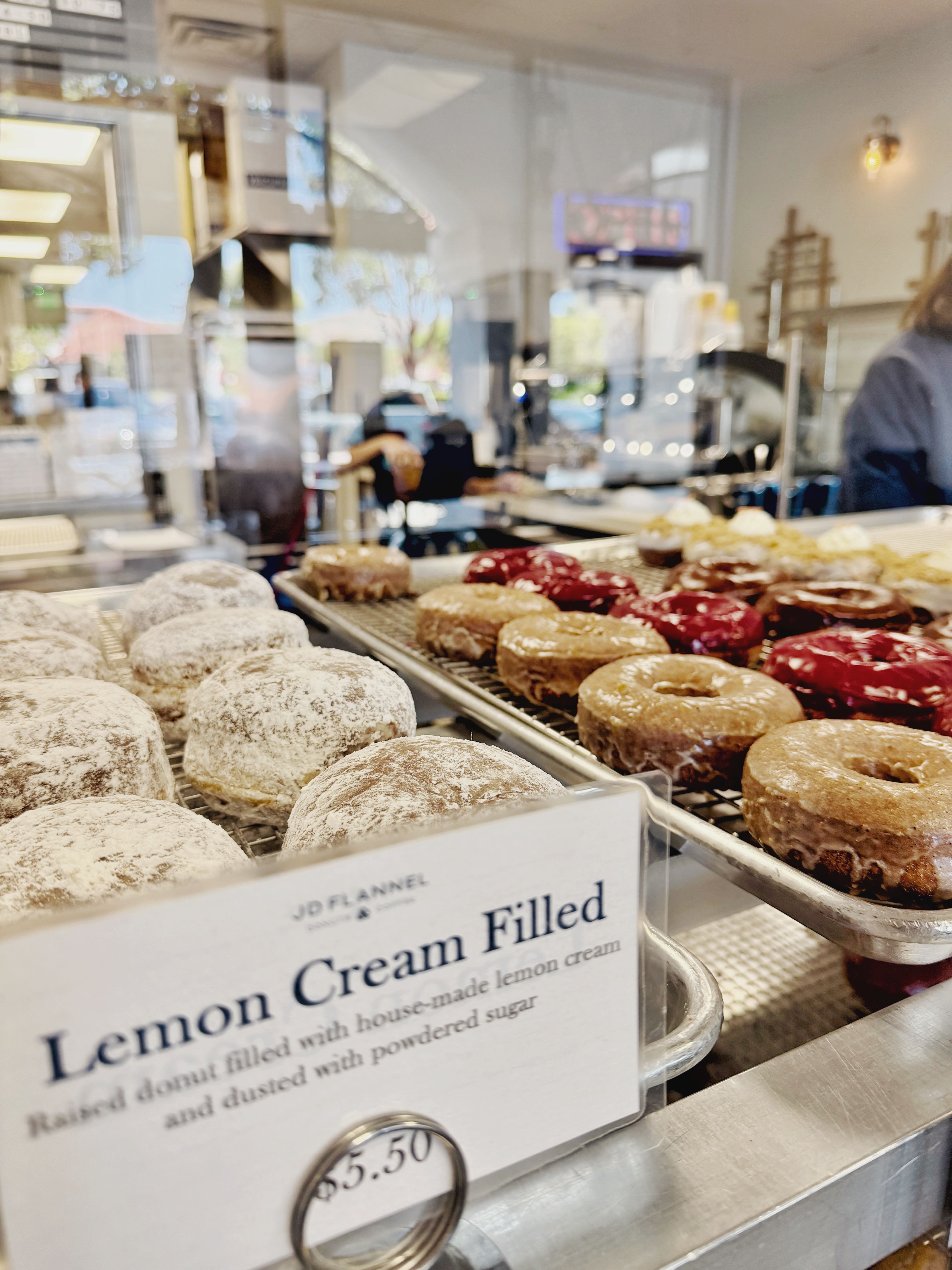 JD Flannel Donuts in San Juan Capistrano — from-scratch craft donuts displayed at the Del Obispo strip mall storefront