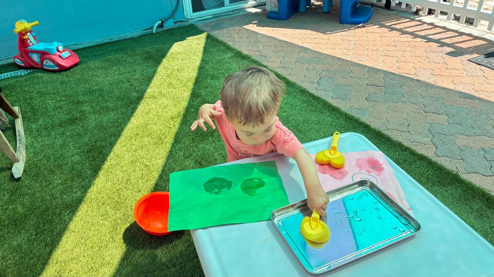 Outdoor art activity table at Little Genius Home Daycare OC in Lake Forest.