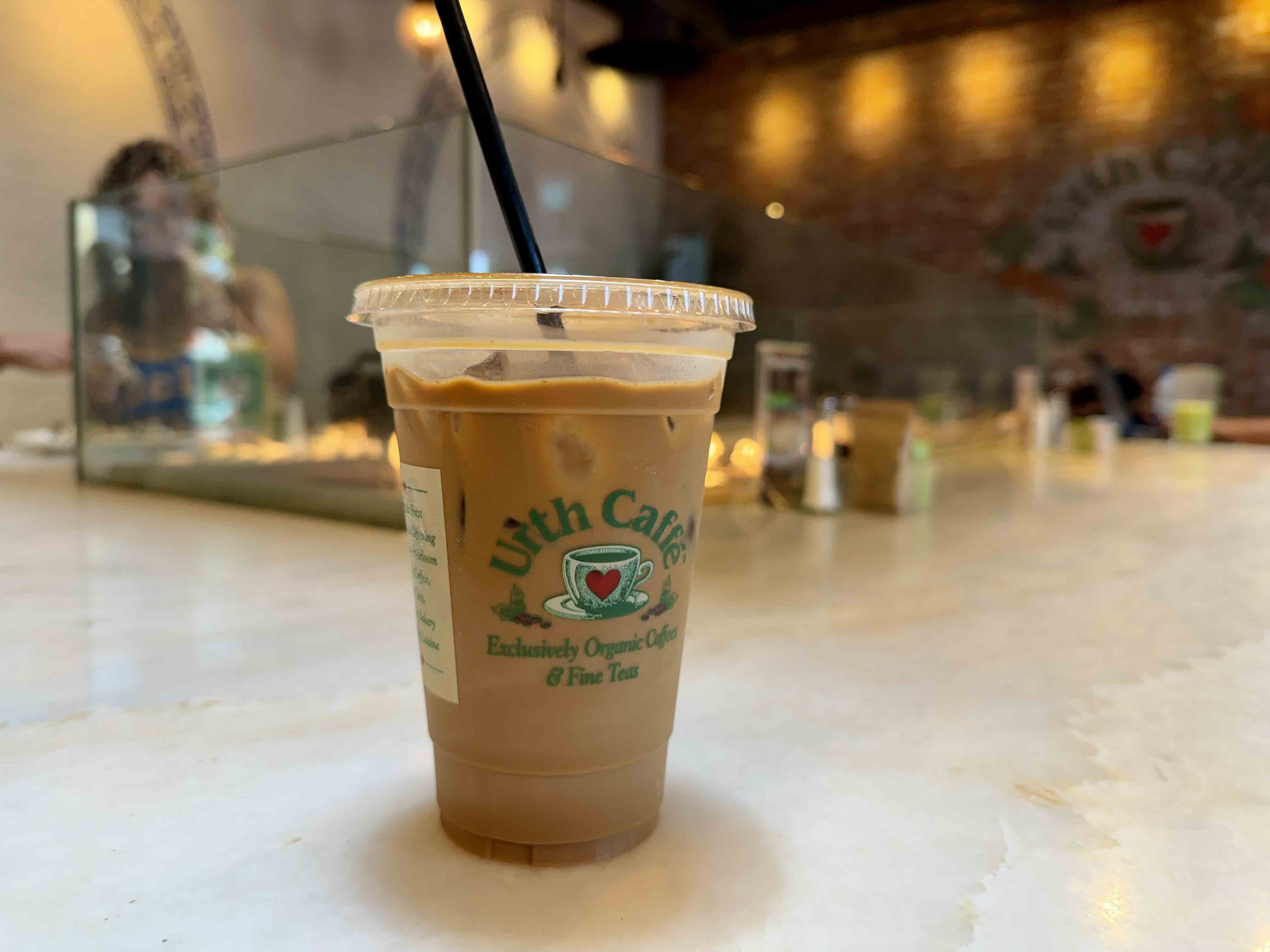 Coffee cup on the built-in fire-feature high-top inside the Urth Caffé Orange dining room.
