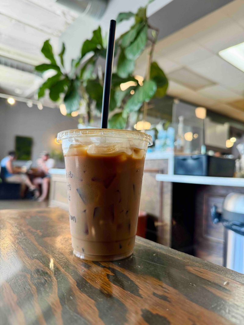 Iced coffee on a live-edge wood counter at Brot Coffee Co in Orange.