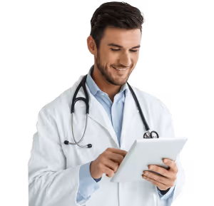 Smiling male doctor using a digital tablet with a stethoscope around his neck.