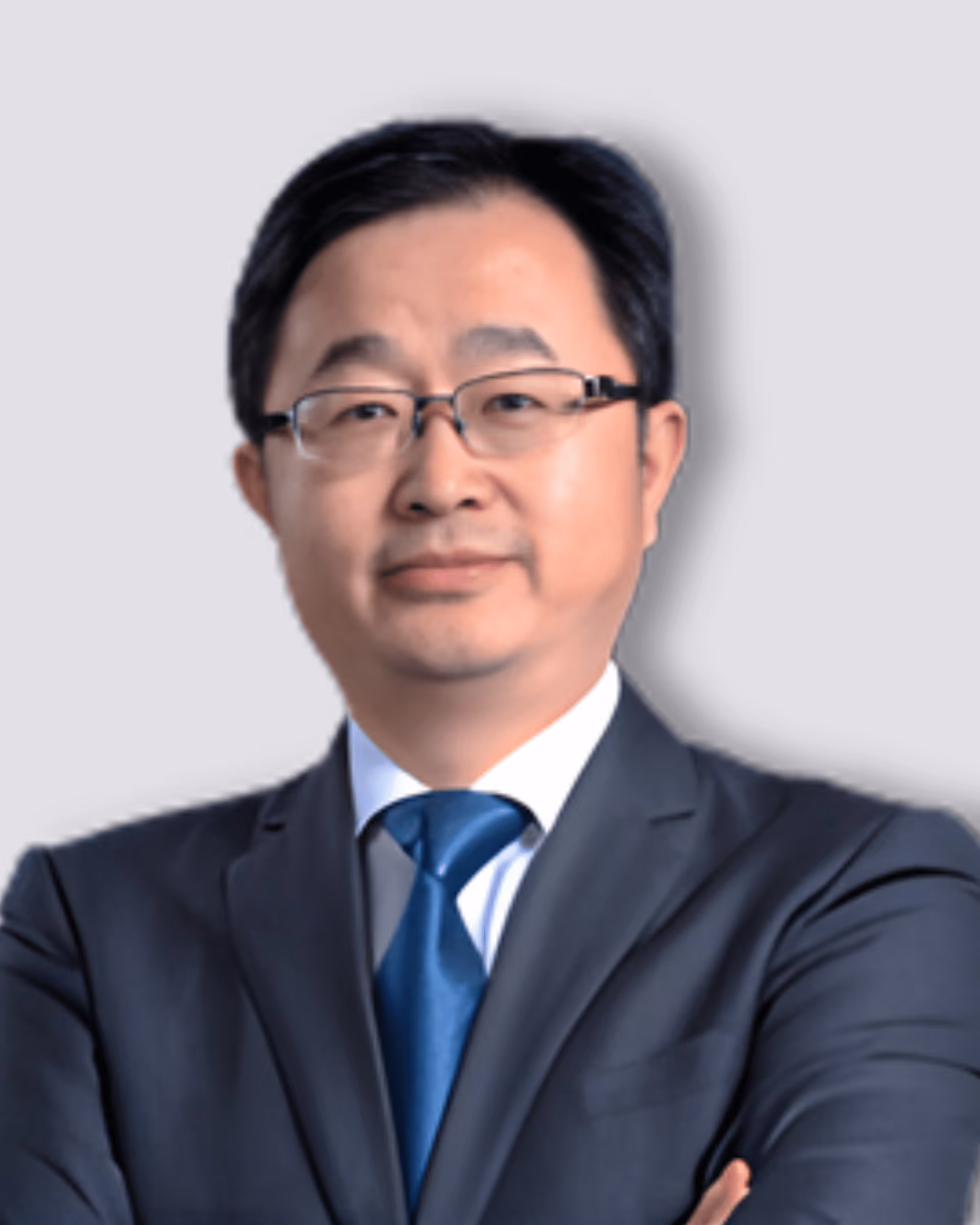 Modern white research institute building surrounded by trees and adjacent to a street under a clear blue sky.